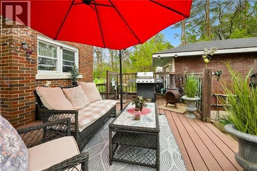 Spacious outdoor deck featuring composite decking, brick exterior wall, and a full-size outdoor umbrella - 786 S Stirling Avenue S, Kitchener, ON - Outdoor With Deck Patio Veranda With Exterior