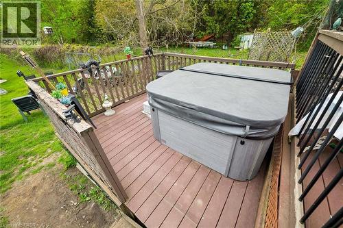 Spacious outdoor deck featuring composite decking, sturdy wood railings, and a built-in hot tub with a protective cover - 786 S Stirling Avenue S, Kitchener, ON - Outdoor With Deck Patio Veranda With Exterior