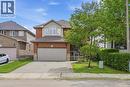 Brick and stucco exterior featuring a double-car garage with a paved driveway - 84 Duncairn Crescent, Hamilton, ON  - Outdoor 