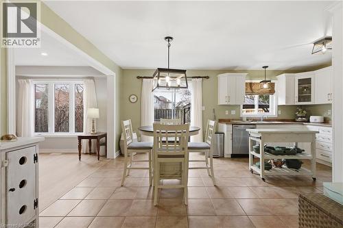 Spacious eat-in kitchen featuring tile flooring, white cabinetry, and stainless steel appliances - 84 Duncairn Crescent, Hamilton, ON - Indoor