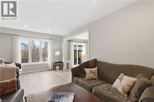 Bright living area featuring a large window with white trim, recessed lighting, and wood-finish flooring - 84 Duncairn Crescent, Hamilton, ON - Indoor Photo Showing Living Room