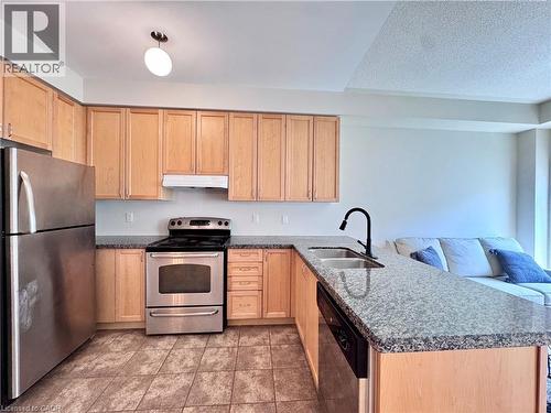 Kitchen featuring light wood cabinetry, stainless steel appliances, granite-style countertops, and tiled flooring - 110 Highland Road E Unit# 53, Kitchener, ON - Indoor Photo Showing Kitchen With Double Sink