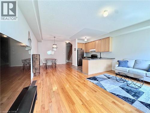 Open-concept living area featuring wood-finish flooring, recessed lighting, and a neutral color palette - 110 Highland Road E Unit# 53, Kitchener, ON - Indoor Photo Showing Other Room