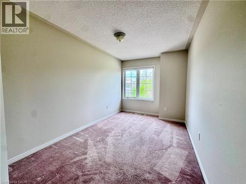 Carpeted room with a ceiling-mounted light fixture, white baseboards, and a window with white trim - 110 Highland Road E Unit# 53, Kitchener, ON - Indoor Photo Showing Other Room