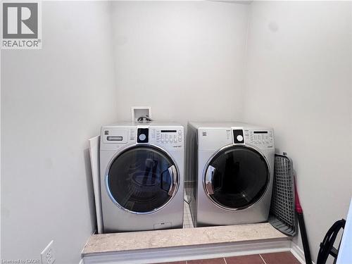 Dedicated laundry area featuring a front-loading washer and dryer, white walls, and a tiled floor - 110 Highland Road E Unit# 53, Kitchener, ON - Indoor Photo Showing Laundry Room