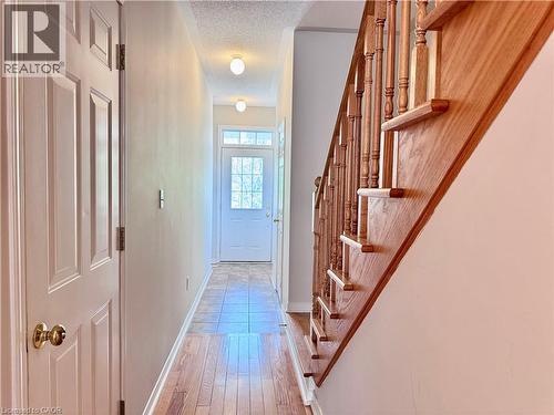 Entryway featuring a wood-finish staircase, paneled interior doors, and a front door with glass inserts - 110 Highland Road E Unit# 53, Kitchener, ON - Indoor Photo Showing Other Room