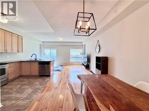 Open-concept living space with wood-finish flooring extending into the dining area - 110 Highland Road E Unit# 53, Kitchener, ON - Indoor Photo Showing Kitchen