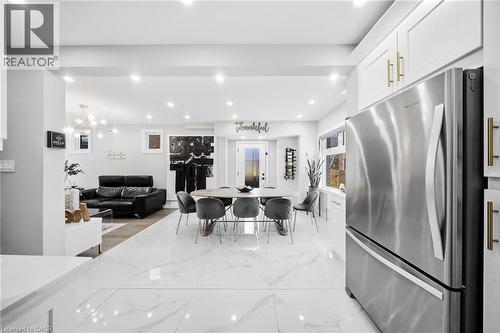 Dining room featuring light marble finish floors and hanging lights - 273 Stinson Crescent, Hamilton, ON - Indoor