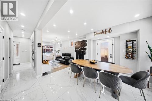 Dining area with hanging lights and light marble finish flooring - 273 Stinson Crescent, Hamilton, ON - Indoor Photo Showing Dining Room