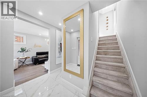 Stairway featuring marble look tile flooring and recessed lighting - 273 Stinson Crescent, Hamilton, ON - Indoor Photo Showing Other Room