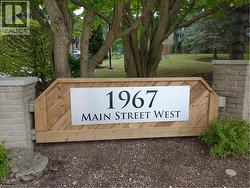 Wood-clad sign featuring a metal address plaque - 