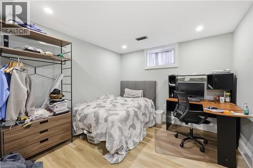 Bedroom featuring light wood-style flooring, a desk, and recessed lighting - 129 Jackson Street W, Hamilton, ON - Indoor