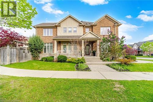 Two-story brick and siding residence featuring a covered front porch supported by columns - 58 Doon Creek Street, Kitchener, ON - Outdoor With Facade