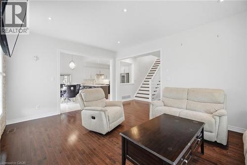 Spacious living area featuring wood-finish flooring, recessed lighting, and white baseboards - 58 Doon Creek Street, Kitchener, ON - Indoor Photo Showing Living Room