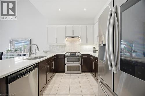Modern kitchen featuring a stainless steel French door refrigerator, a stainless steel range with a double oven, and a stainless steel dishwasher - 58 Doon Creek Street, Kitchener, ON - Indoor Photo Showing Kitchen With Double Sink With Upgraded Kitchen