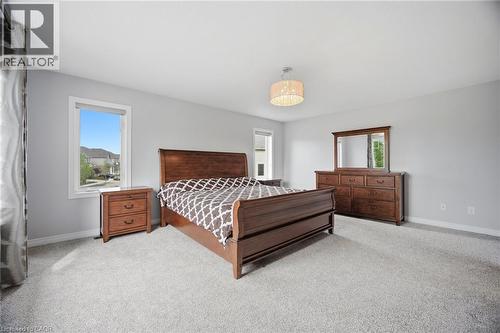 Spacious bedroom featuring light gray walls and plush gray carpeting - 58 Doon Creek Street, Kitchener, ON - Indoor Photo Showing Bedroom