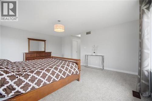 Spacious room with light gray walls and plush carpet - 58 Doon Creek Street, Kitchener, ON - Indoor Photo Showing Bedroom