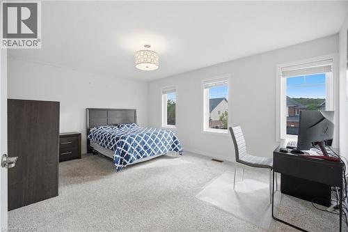 Spacious room featuring light-colored carpeting and white walls - 58 Doon Creek Street, Kitchener, ON - Indoor Photo Showing Bedroom