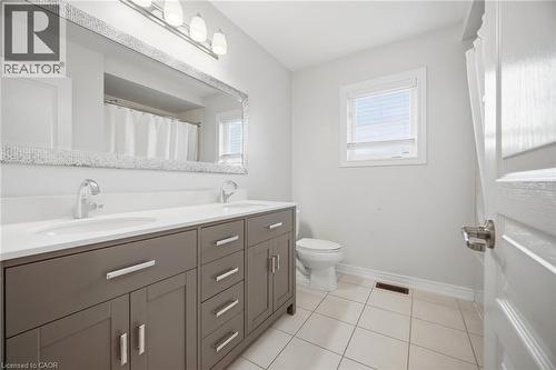 Dual vanity with a white countertop and undermount sinks - 58 Doon Creek Street, Kitchener, ON - Indoor Photo Showing Bathroom