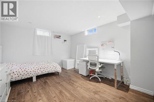 Spacious room featuring wood-finish flooring, white walls, and recessed lighting - 58 Doon Creek Street, Kitchener, ON - Indoor Photo Showing Bedroom