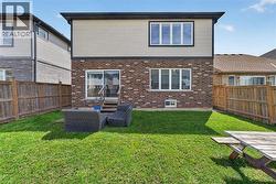Expansive grassy backyard featuring a wooden privacy fence - 