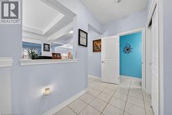 Tiled flooring in a hallway with a pass-through window and a built-in closet - 