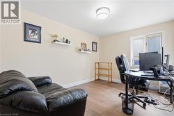 Neutral tone painted walls and wood-finish flooring define this versatile room - 