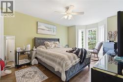 Wood-finish flooring with a bay window featuring multiple panes - 