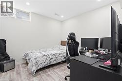 Room featuring wood-finish flooring, white walls, and recessed lighting - 