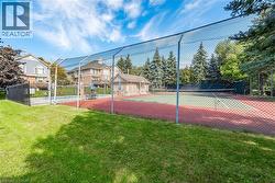 Full-size tennis court featuring a red and green hard surface - 