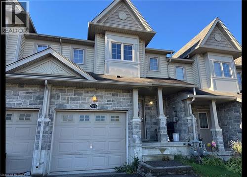Townhome exterior featuring stone veneer and light-toned siding - 517 Northbrook Place, Kitchener, ON - Outdoor With Facade