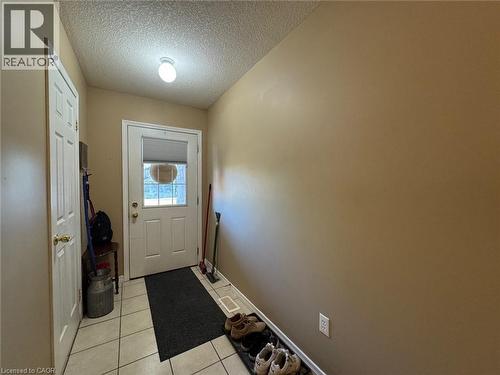 Entryway featuring neutral wall tones, white paneled doors, and a tiled floor - 517 Northbrook Place, Kitchener, ON - Indoor Photo Showing Other Room