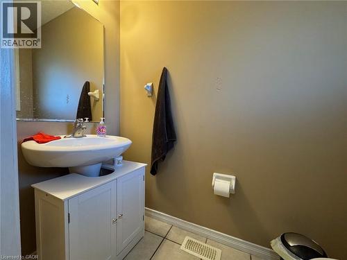 Pedestal sink with chrome faucet, complemented by a white vanity cabinet below - 517 Northbrook Place, Kitchener, ON - Indoor Photo Showing Bathroom