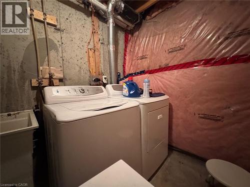 Laundry area featuring a top-loading washing machine, a front-loading dryer, and a utility sink - 517 Northbrook Place, Kitchener, ON - Indoor Photo Showing Laundry Room