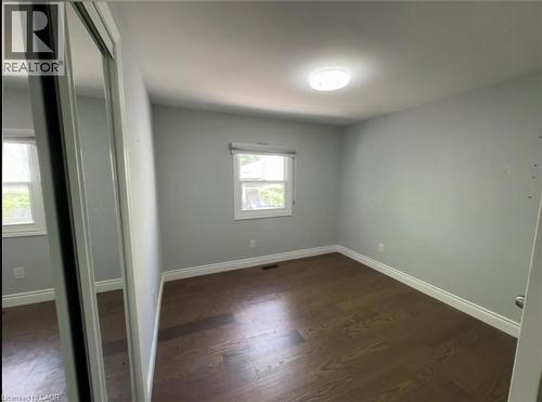 Room featuring wood-finish flooring, light grey wall paint, and white baseboards - 28 Timberlane Crescent Unit# Upper, Kitchener, ON - Indoor Photo Showing Other Room