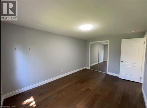 Room featuring wood-finish flooring, light grey walls, white baseboards, and a flush-mount ceiling light - 28 Timberlane Crescent Unit# Upper, Kitchener, ON - Indoor Photo Showing Other Room