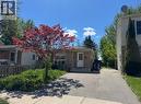 Brick exterior with white entry door and a red-leafed deciduous tree in the front yard - 28 Timberlane Crescent Unit# Upper, Kitchener, ON  - Outdoor 