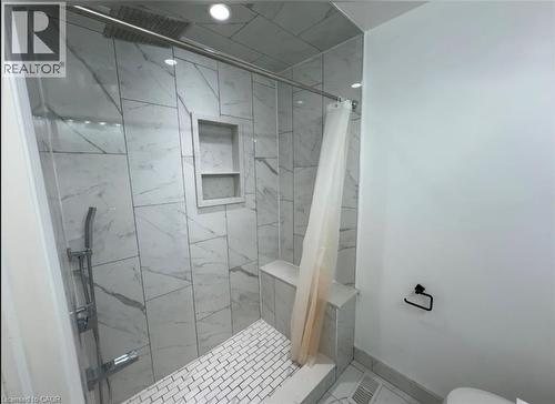 Shower enclosure featuring large format white tile walls with grey veining, a rain showerhead, and a handheld spray attachment - 28 Timberlane Crescent Unit# Upper, Kitchener, ON - Indoor Photo Showing Bathroom