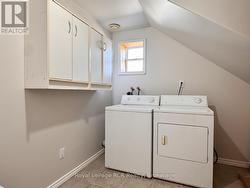 Fully finished laundry room with storage. - 