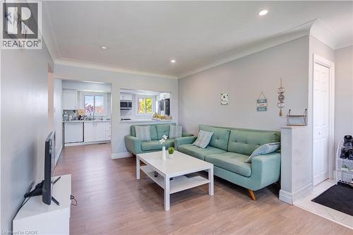 Open concept living space featuring light wood-finish flooring, recessed lighting, and crown molding - 100 Lauris Avenue, Cambridge, ON - Indoor Photo Showing Living Room