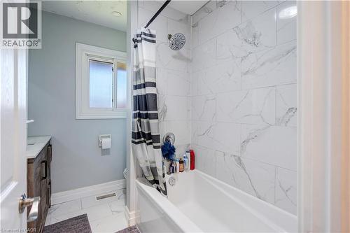 White tiled shower and bathtub combination - 100 Lauris Avenue, Cambridge, ON - Indoor Photo Showing Bathroom