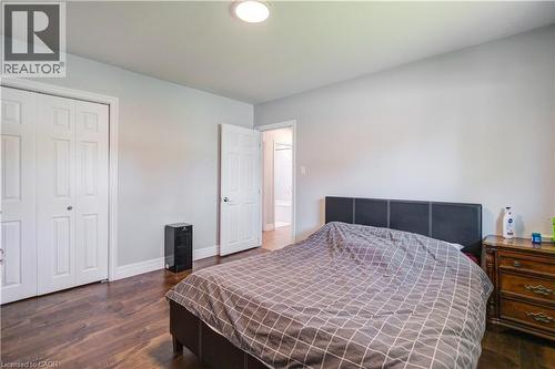 Spacious room featuring wood-finish flooring, light grey wall paint, and white trim - 100 Lauris Avenue, Cambridge, ON - Indoor Photo Showing Bedroom