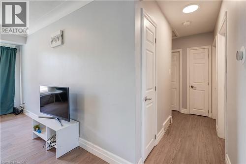 Hallway with multiple paneled doors, recessed lighting, and wood-finish flooring - 100 Lauris Avenue, Cambridge, ON - Indoor Photo Showing Other Room