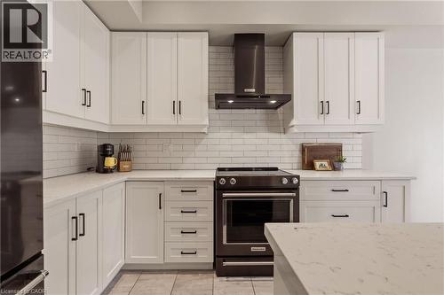 Neutral quartz counters and backsplash. - 81 Beasley Grove, Ancaster, ON - Indoor Photo Showing Kitchen