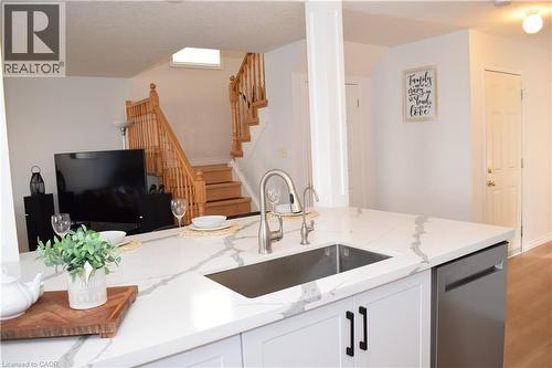 Kitchen island featuring a stainless steel undermount sink and a pull-down faucet - 28 Lemon Grass Street, Kitchener, ON - Indoor Photo Showing Kitchen