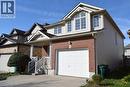 Exterior featuring a brick facade, light-toned siding, and an attached single-car garage - 28 Lemon Grass Street, Kitchener, ON  - Outdoor 