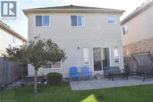 Rear exterior featuring light-toned horizontal siding and a dark shingle roof - 28 Lemon Grass Street, Kitchener, ON - Outdoor With Deck Patio Veranda With Exterior