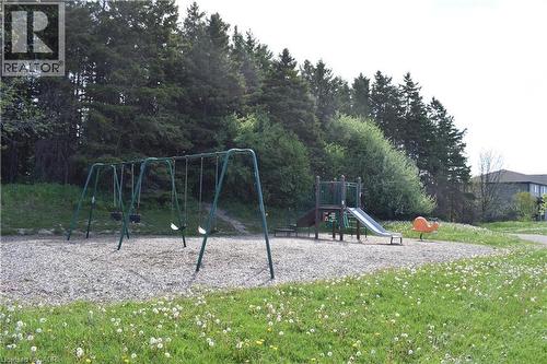 Community playground featuring a swing set, slide structure, and spring rider - 28 Lemon Grass Street, Kitchener, ON - Outdoor