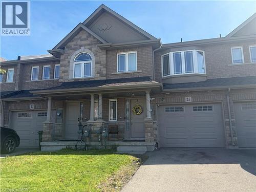 Stone and brick facade featuring a covered front porch with stone pillars - 25 Bethune Avenue, Hamilton, ON - Outdoor With Facade