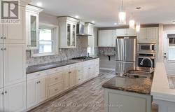 Bright kitchen with stainless steel appliances - 